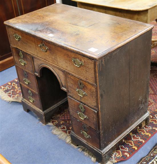 A George II oak kneehole desk W.86cm